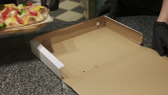 Two Chefs Pack Pizza In Box