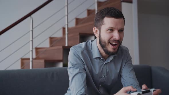 Man Using Console and Playing in Video Games at Home