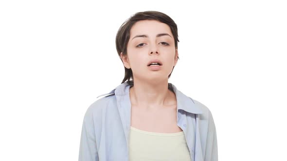 Caucasian Tired Female with Short Brunette Hair Looking at Camera and Making Double Facepalm