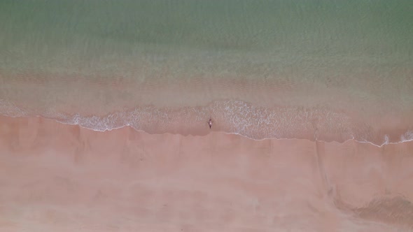 Woman In Bikini Lying In Shallow Tide On Nacpan Beach