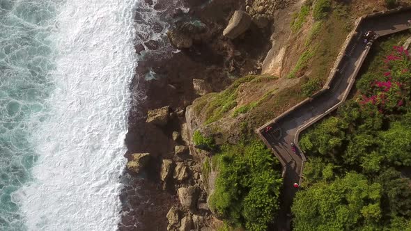 Aerial view above of rock cliff with a pathway, Bali, Indonesia.