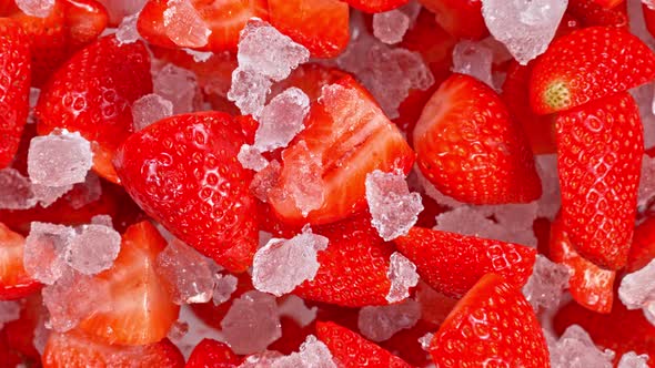 Super Slow Motion Shot of Fresh Strawberries and Crushed Ice Flying Towards Camera at 1000Fps