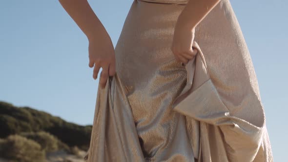 Beautiful Woman Dancing In Gold Dress