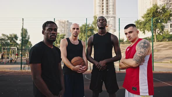 Zoom in Portrait of a Multiethnic Team of Athletes on a Basketball Court