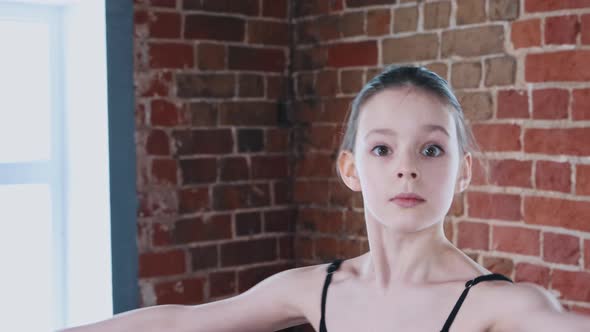 Ballet Dancing Indoors  a Little Gymnastics Girl Dancing in Black Suit on Training