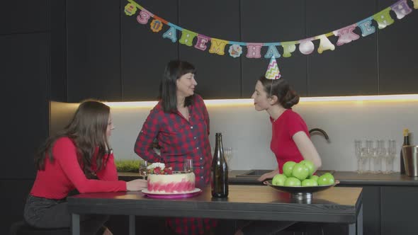 Joyful Mom Giving Gift Box To Daughter at Birthday