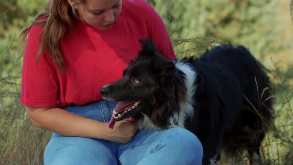 Plump Woman and Her Cute Black Dog Outdoors Together