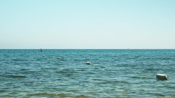 Enclosing buoys float on waves in sea