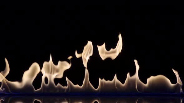 Flash and Fire Streak of Flammable Liquid or Gasoline Against Black Reflective Background