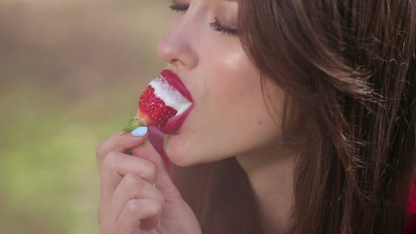 Pretty Woman Seductively Eating Strawberries