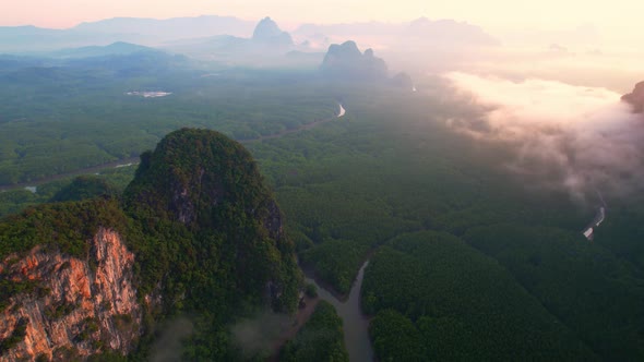 4K : Drone flying above the clouds, Limestone mountains with mangrove