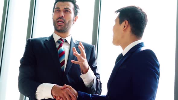 Business People Handshake in Corporate Office