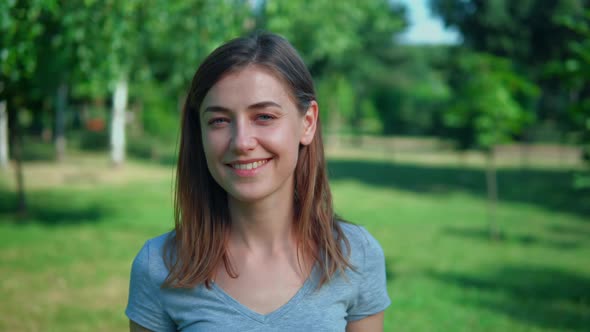 Cheerful Female Standing in Garden