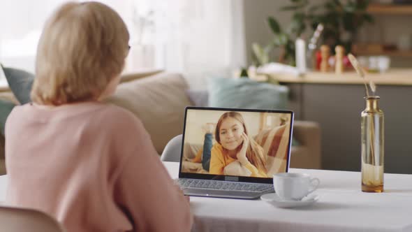 Senior Woman Chatting with Granddaughter on Video Call