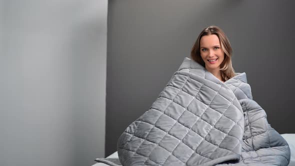 Adorable Feminine Posing on Bed Covering By Cozy Gray Blanket