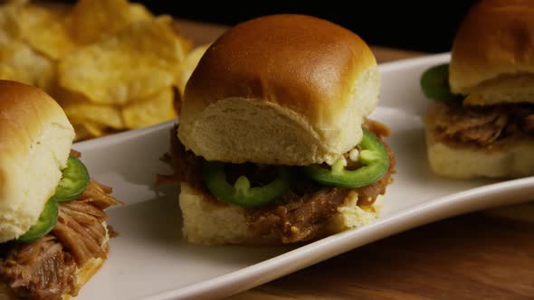 Rotating shot of delicious pulled pork sliders - BBQ 