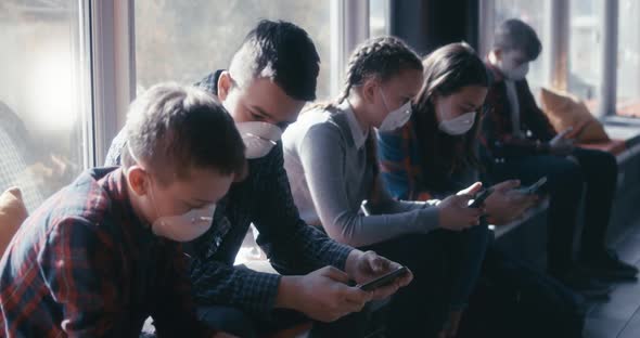 Face Mask Wearing Students Using Smartphone