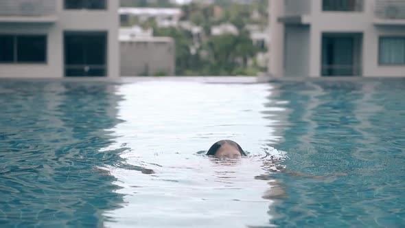 Smiling Lady Emerges From Water in Swimming Pool Slow Motion