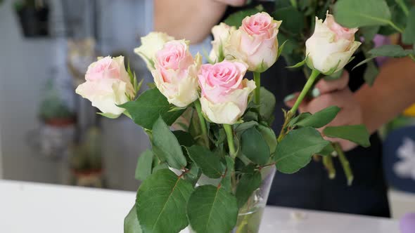 Woman Professional Florist Puts Roses on Vase in Flower Shop Hands Closeup