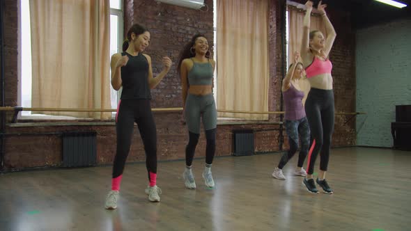 Happy Multiracial Sporty Females Dancing at Gym