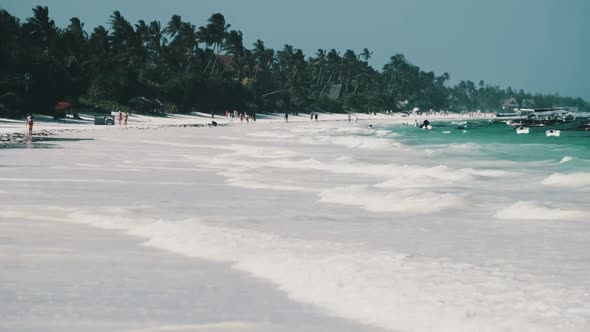 Paradise White Sandy Beach with Turquoise Ocean and Waves at Low Tide Zanzibar