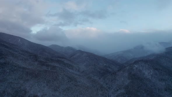 Aerial View of the Mountains Range with Clouds and Storm Clouds in Twilight