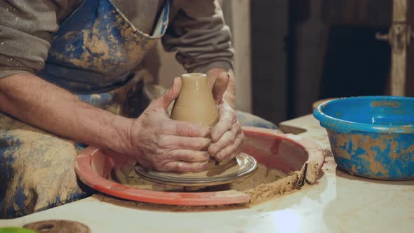 Potter Hands Making Clay on Potter's Wheel