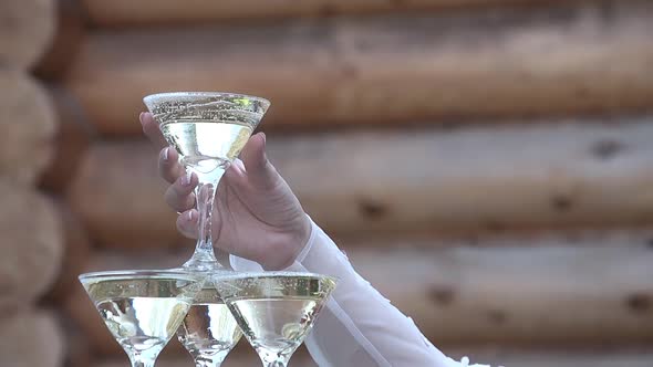 Girl Takes a Glass of Champagne From the Top of a Glass of Glasses of Champagne