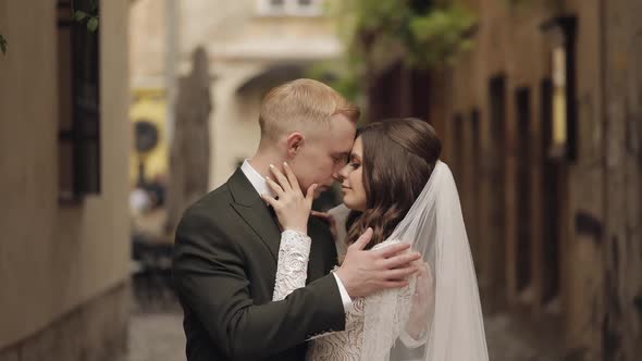 Newlyweds Caucasian Groom with Bride Walking Embracing Hugs in City Wedding Couple in Love