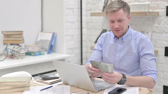 Businessman Counting Dollar Happily