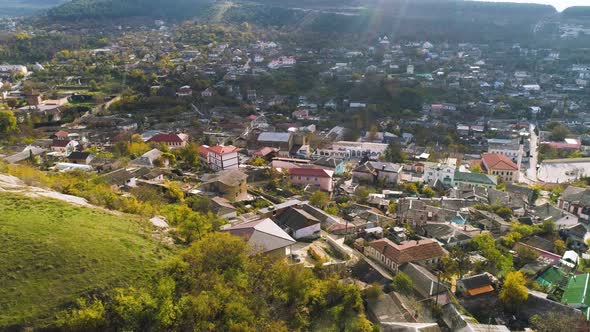 Top View Of City Located In Valley With Hills