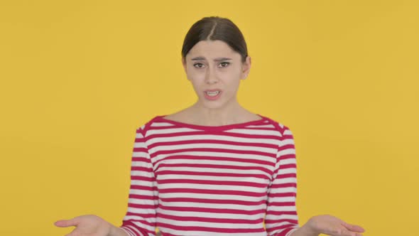 Angry Spanish Woman Fighting on Yellow Background