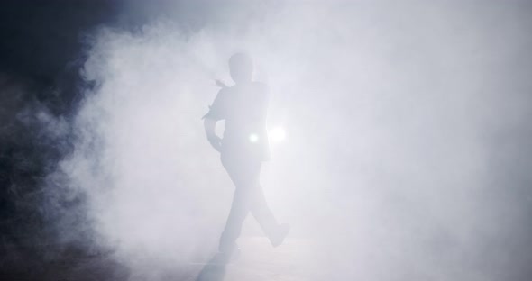 silhouette of a female dancer performing hip hop dance in slow motion