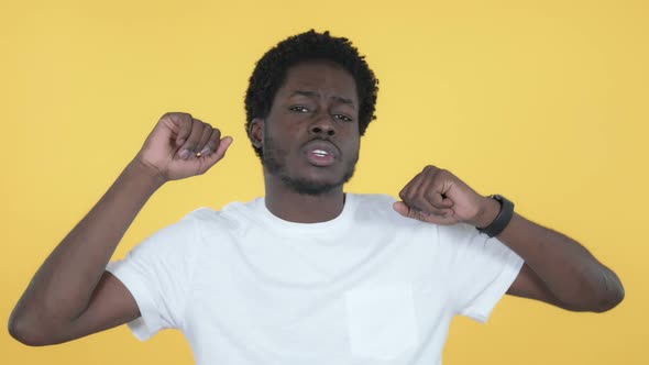 Happy African Man Dancing Yellow Background