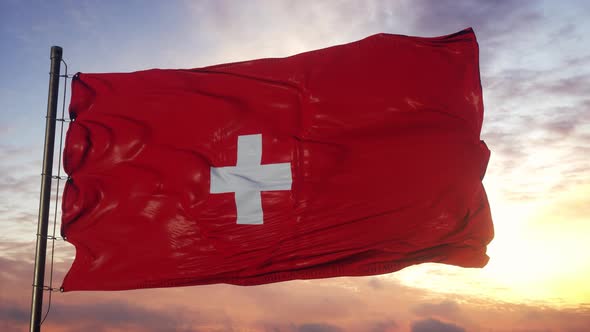Flag of Switzerland Waving in the Wind Against Deep Beautiful Sky at Sunset