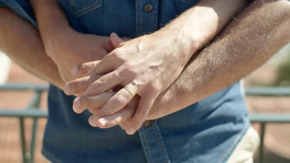 Closeup Shot of Gays Hands with Engagement Ring on Finger