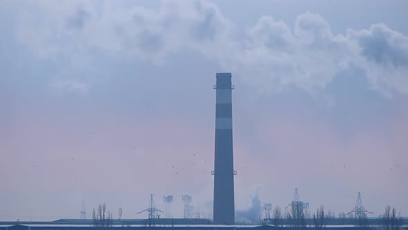 Industrial smog. Chimney and electric transmission lines. Heavy industry pattern.