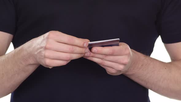 Credit Card in Hands. Planned Online Shopping. White. Close Up