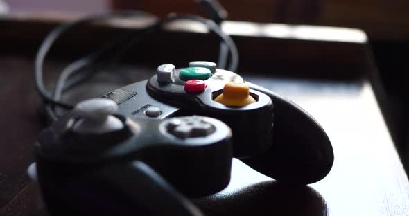 A video game controller on a desk after a child is done gaming in his room.