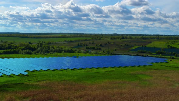 Aerial View Solar Panels Park in Countryside Landscape with Cloud Sky