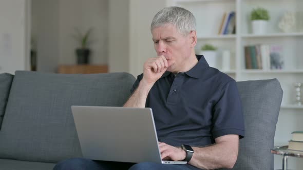 Sick Middle Aged Businessman Coughing on Sofa