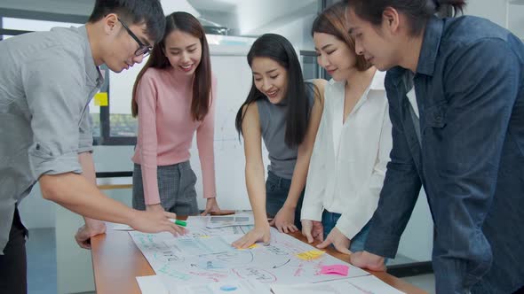 Group of asian creative employee standing and brainstorming stategy plan