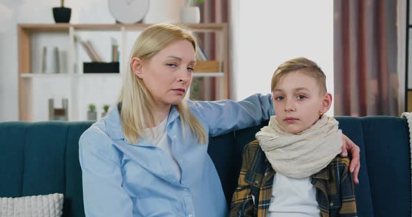 Mother Looking First Into Eyes of Her Sick Exhausted Son and Then Into Camera