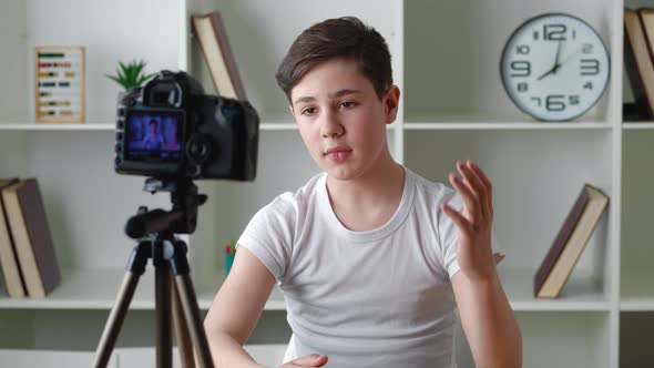 Portrait of Boy Videoblogger 13 Years Old Filming New Vlog Video with Professional Camera at Home