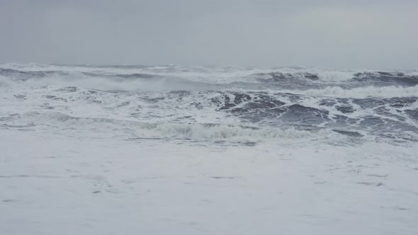 White Storm Waves Crashing Onto Black Sand Beach