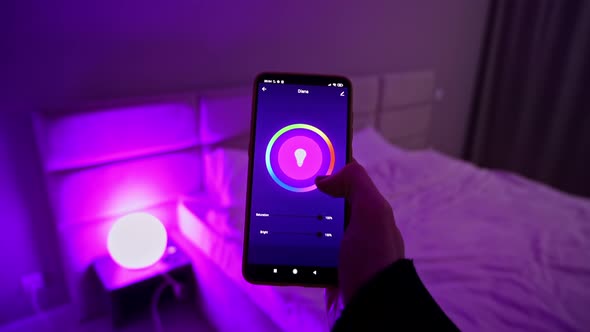 Woman hands holding smartphone, changing color light in hue app