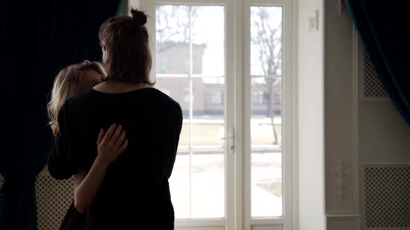 Sensual Embrace of Young Lovers Blonde Woman and Her Boyfriend are Hugging in Big Light Room