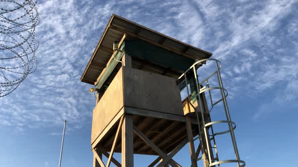 concept shot of wooden military watchtower on low angle against blue sky environment with white cirr