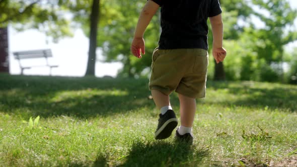 A child walking through the grass.