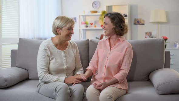 Woman and Godmother Laughing Together Holding Hands, Family Communication, Fun